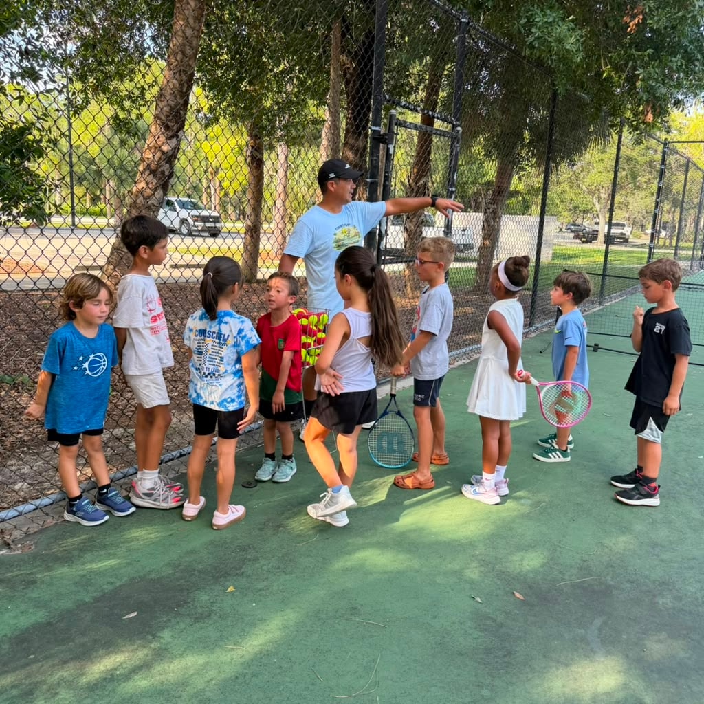 Kids tennis lesson group outdoor court